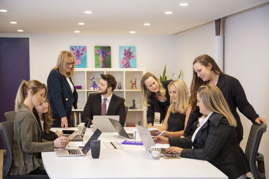 purple giraffe team of marketers discussing work