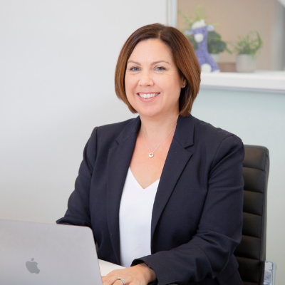 Bree Wood marketing consultant at Purple Giraffe marketing consultant company smiling at the camera working at desk professional marketing consultants