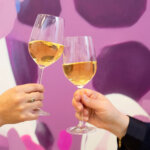 Two wine glasses toasting to symbolise the celebration of authenticity in wine marketing