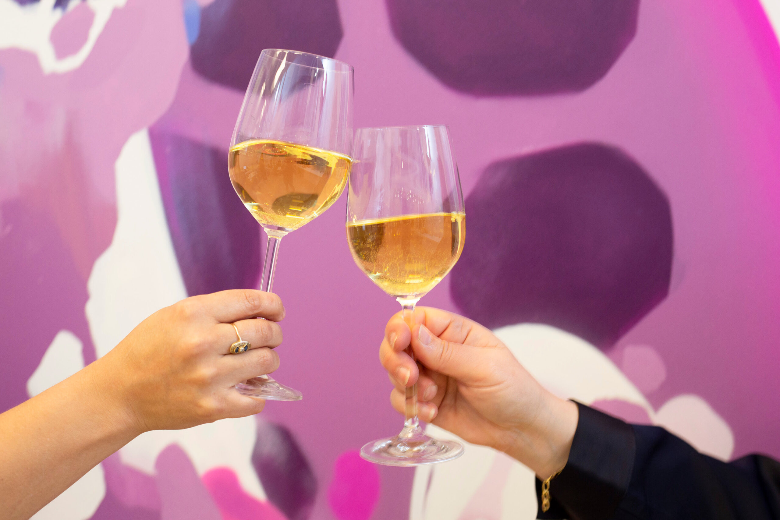 Two wine glasses toasting to symbolise the celebration of authenticity in wine marketing