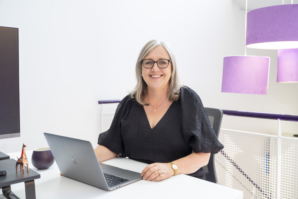 Lynda Schenk Head Giraffe sitting at desk