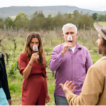 Winery guests enjoying a wine tasting experience out in the vineyard.