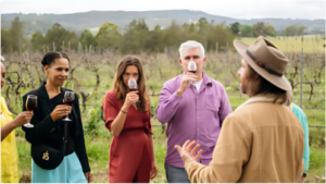 Winery guests enjoying a wine tasting experience out in the vineyard.