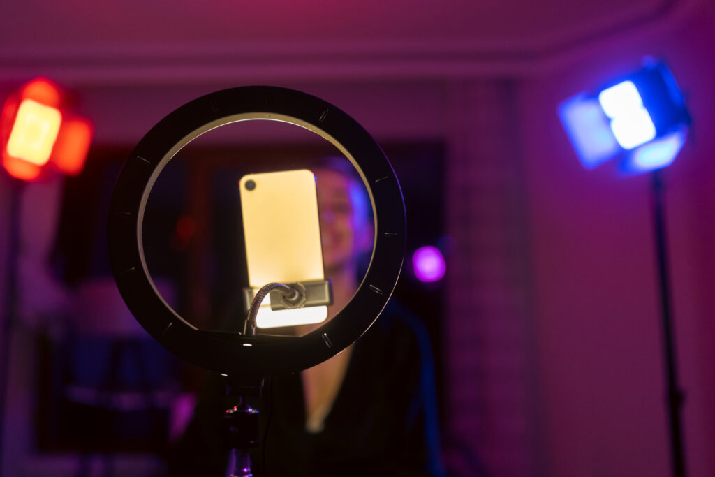 Influencer vs. collaborator: An influencer casting content, using a ring light.
