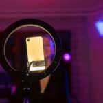 Influencer vs. collaborator: An influencer casting content, using a ring light.