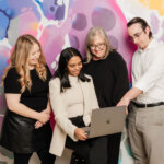 The Purple Giraffe team discussing outsourced vs fractional marketing strategies to support business growth.