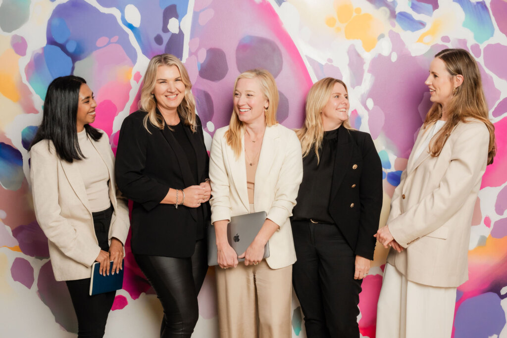 A group of Purple Giraffe Marketing Consultants laughing.