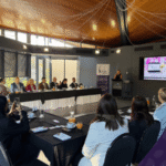 Group of people sitting around a table for a corporate presentation