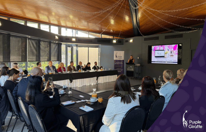 Group of people sitting around a table for a corporate presentation